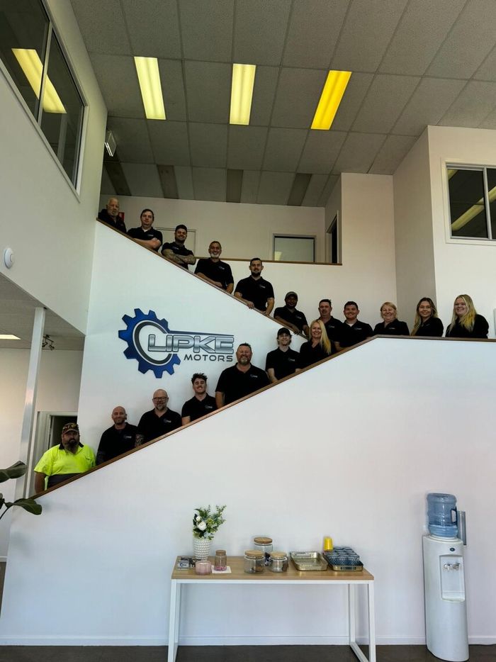 The Lipke Motors team on the stairs in the reception area